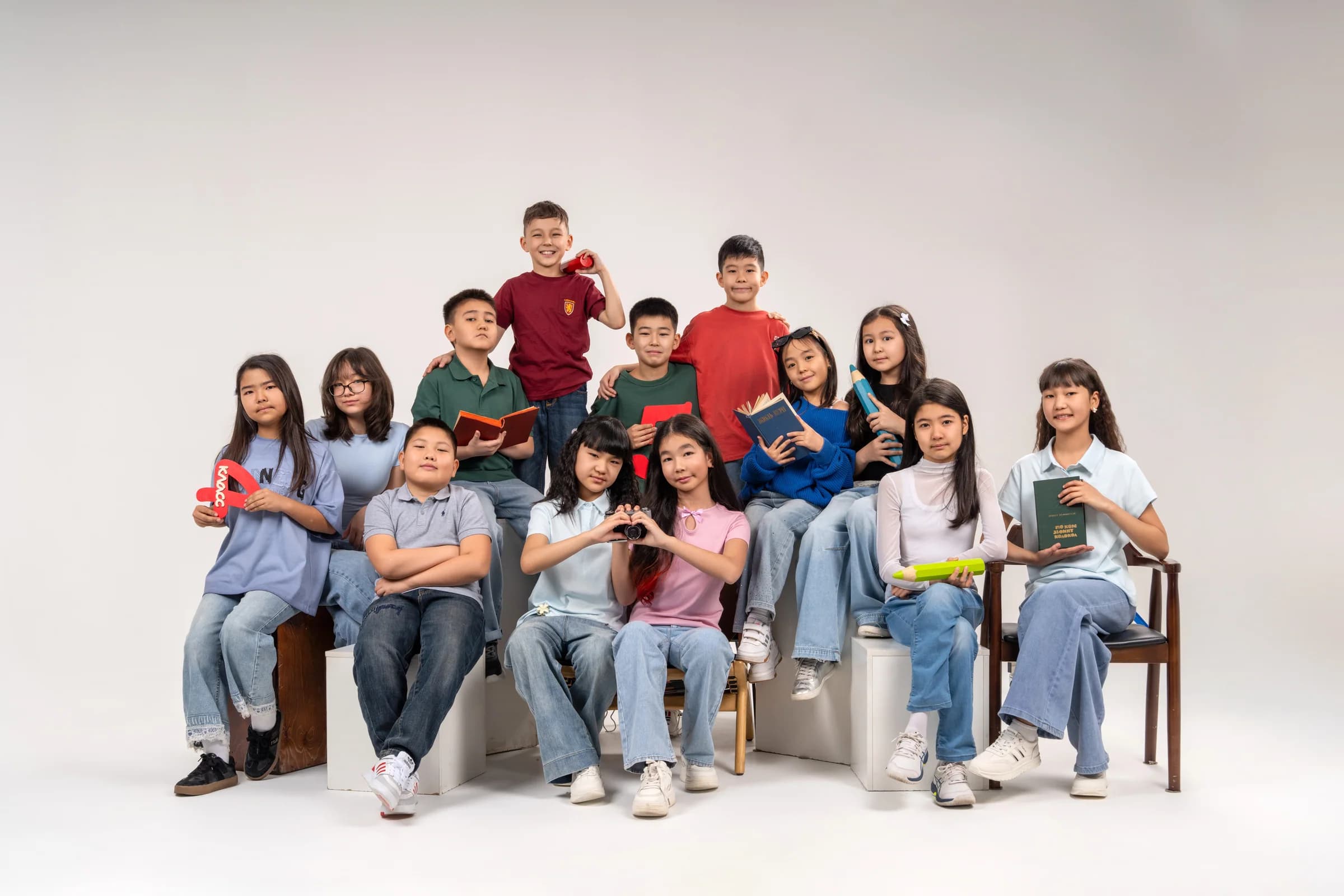 A junior class on a light studio background