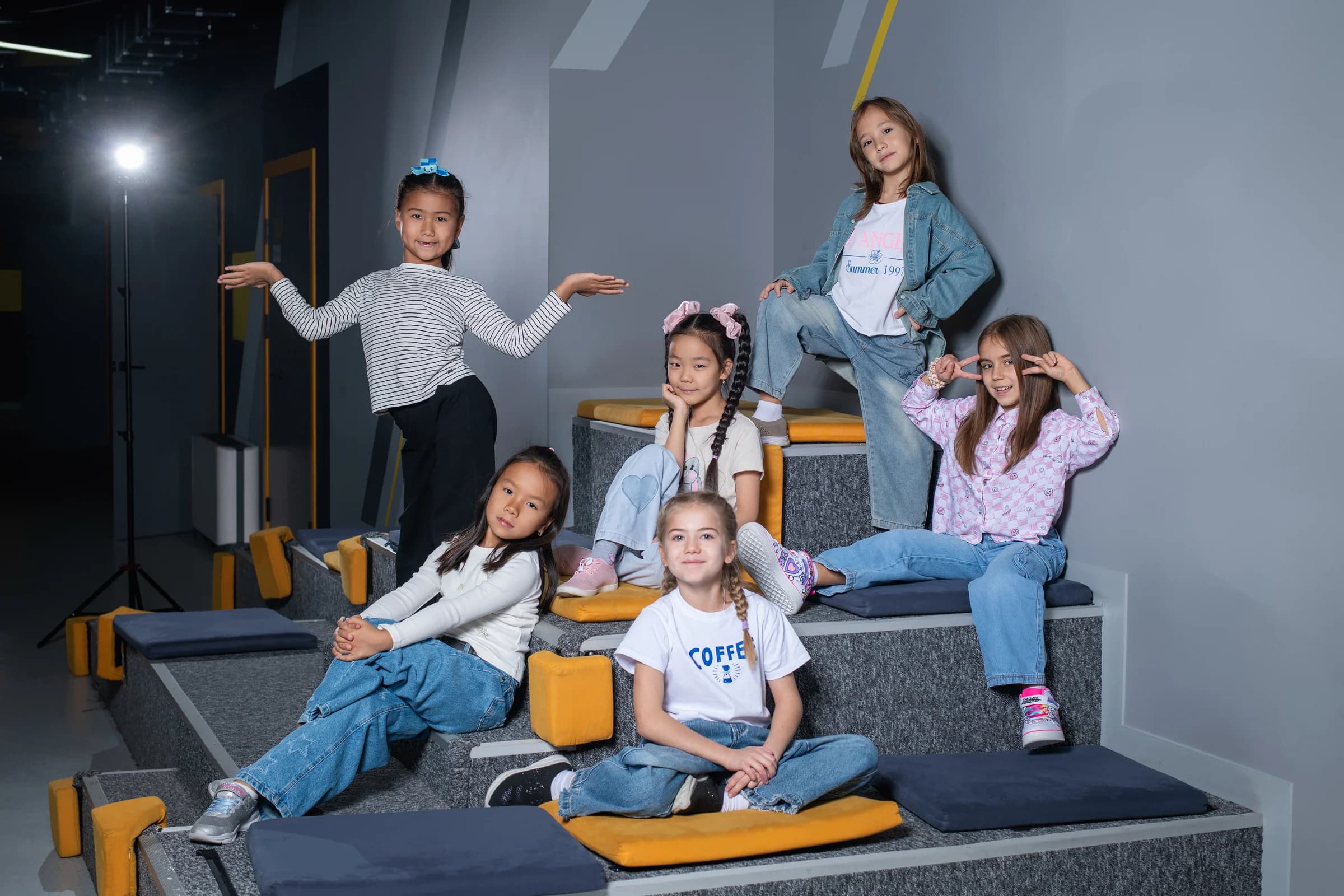 Children on stepped seats in a school space