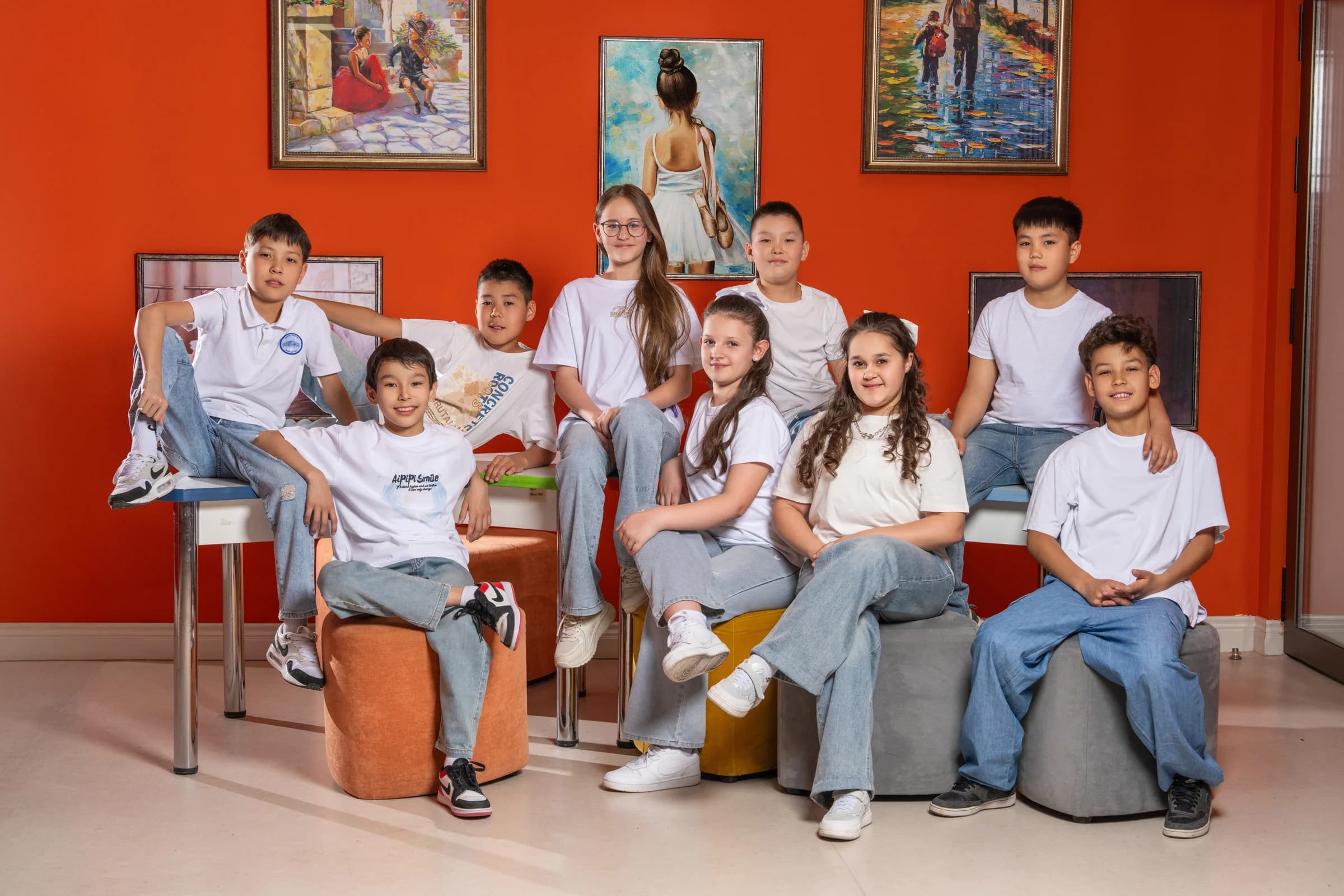 A junior class portrait in an interior with paintings